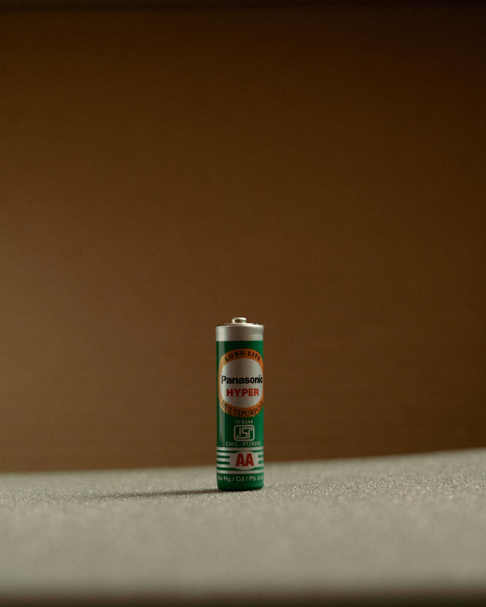 A single Panasonic AA battery displayed against a neutral backdrop.